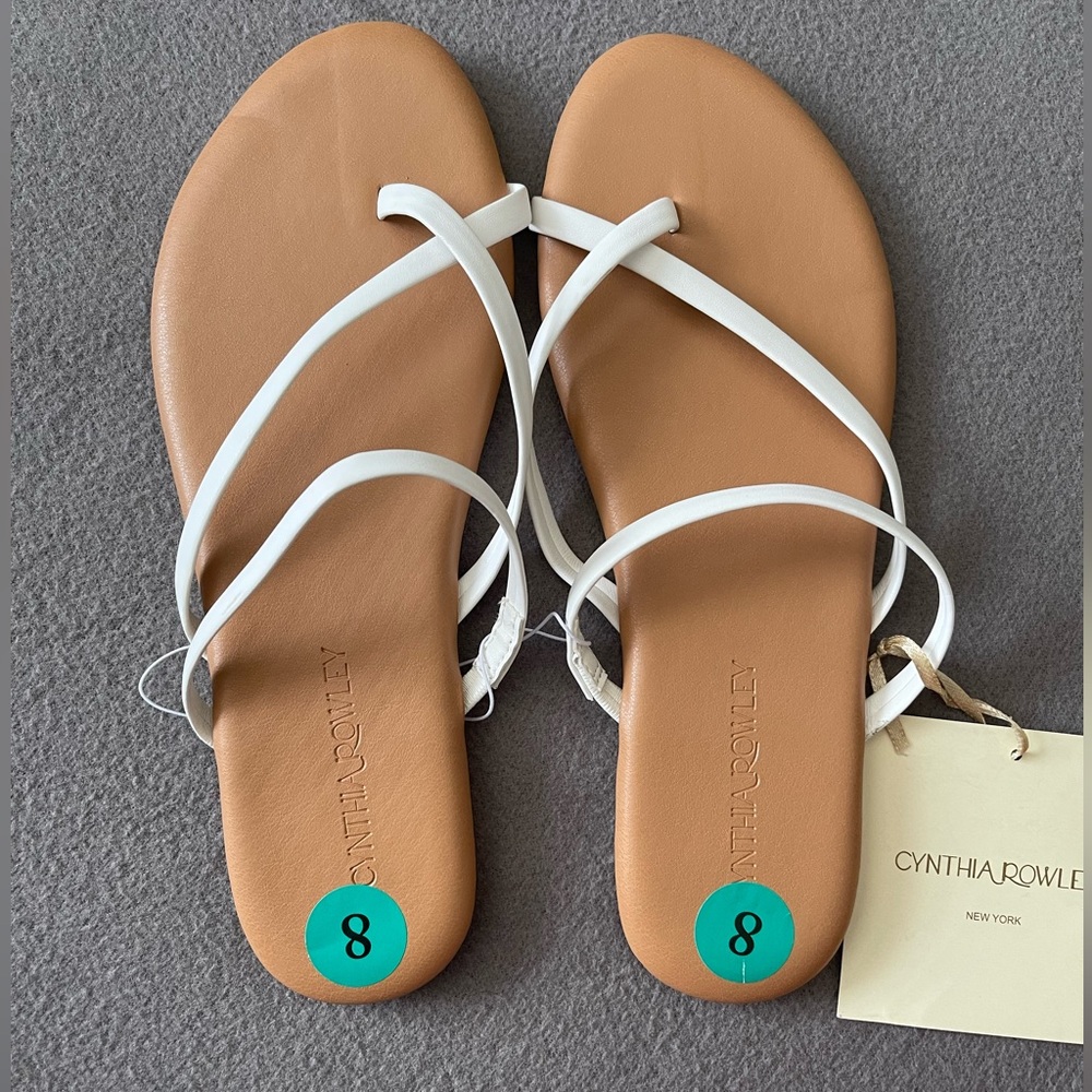 White strappy sandal/slide, khaki bottom.